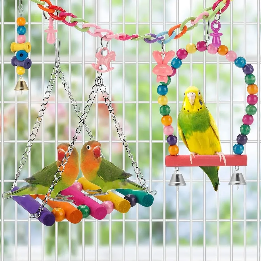 Budgie swinging beside the bells in the parakeet toys set