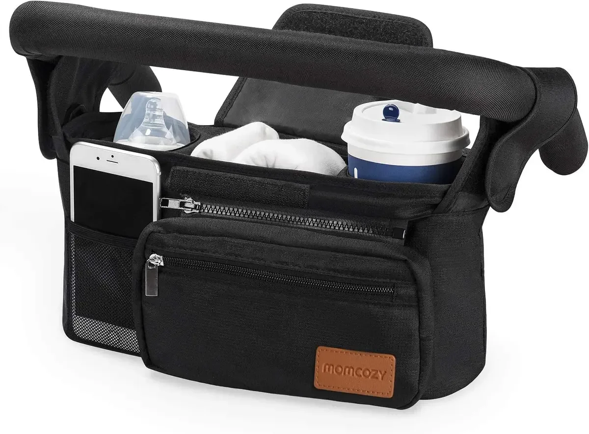 Stroller organizer strapped to a stroller handlebar with drinks inside