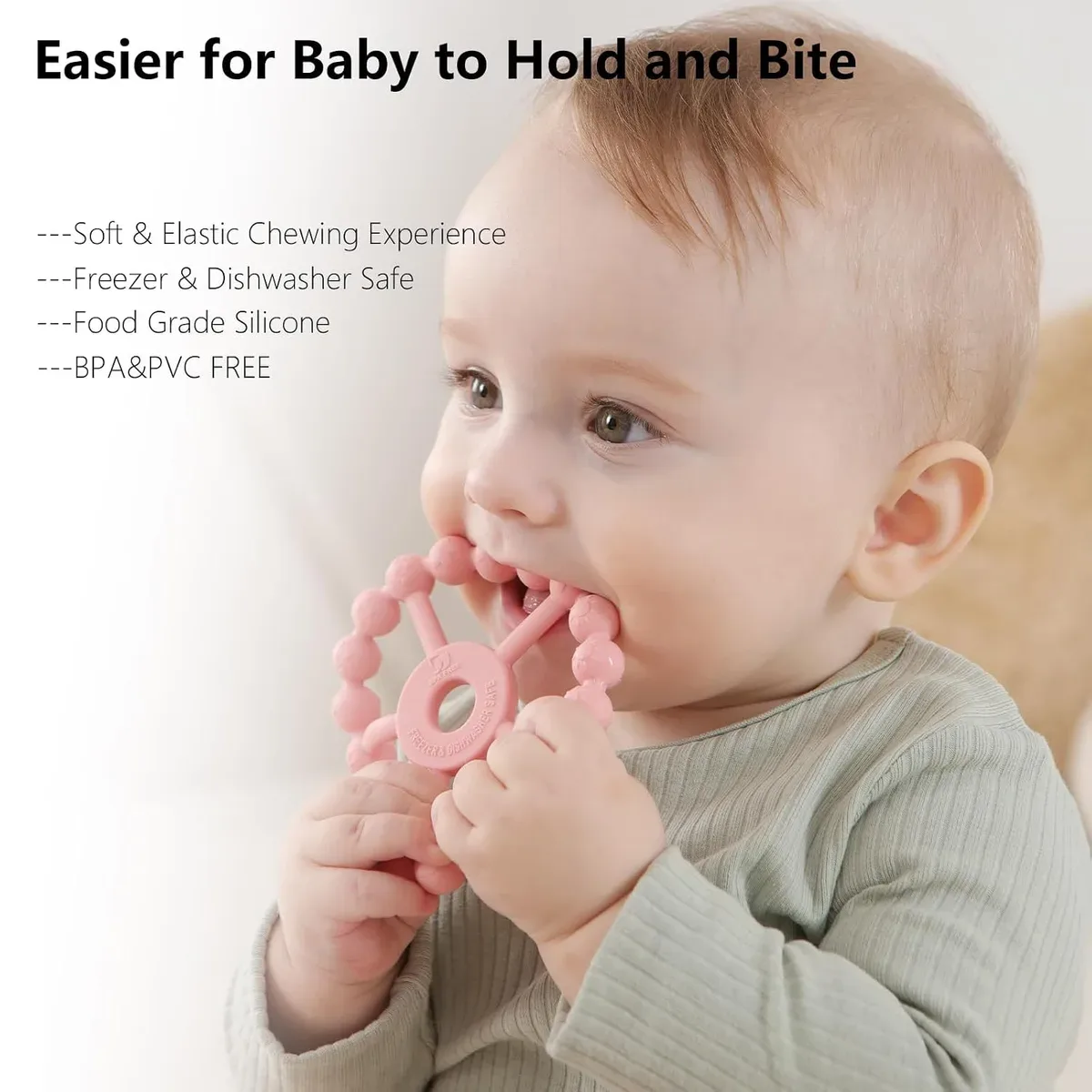 Small baby hands holding a silicone ring teether