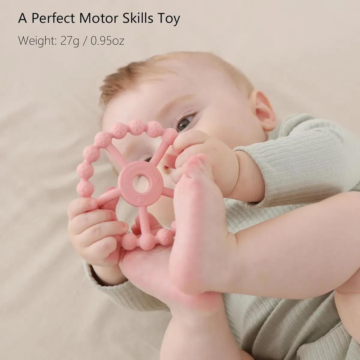 Silicone ring teether helping a baby practice grip and hand control