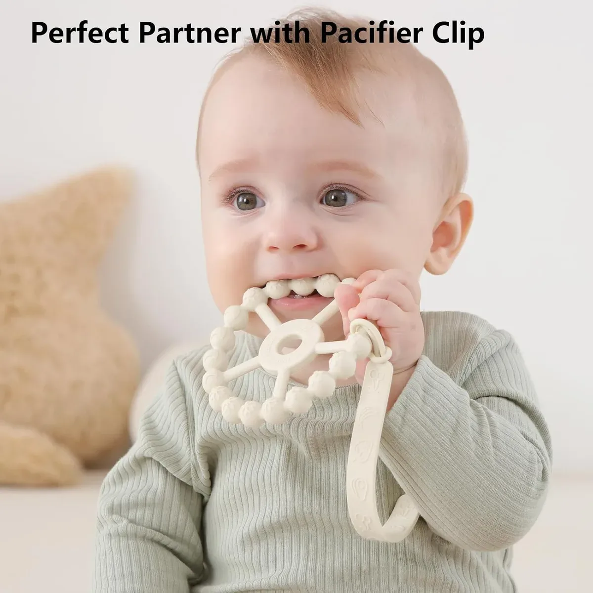 Silicone ring teether attached to a pacifier clip