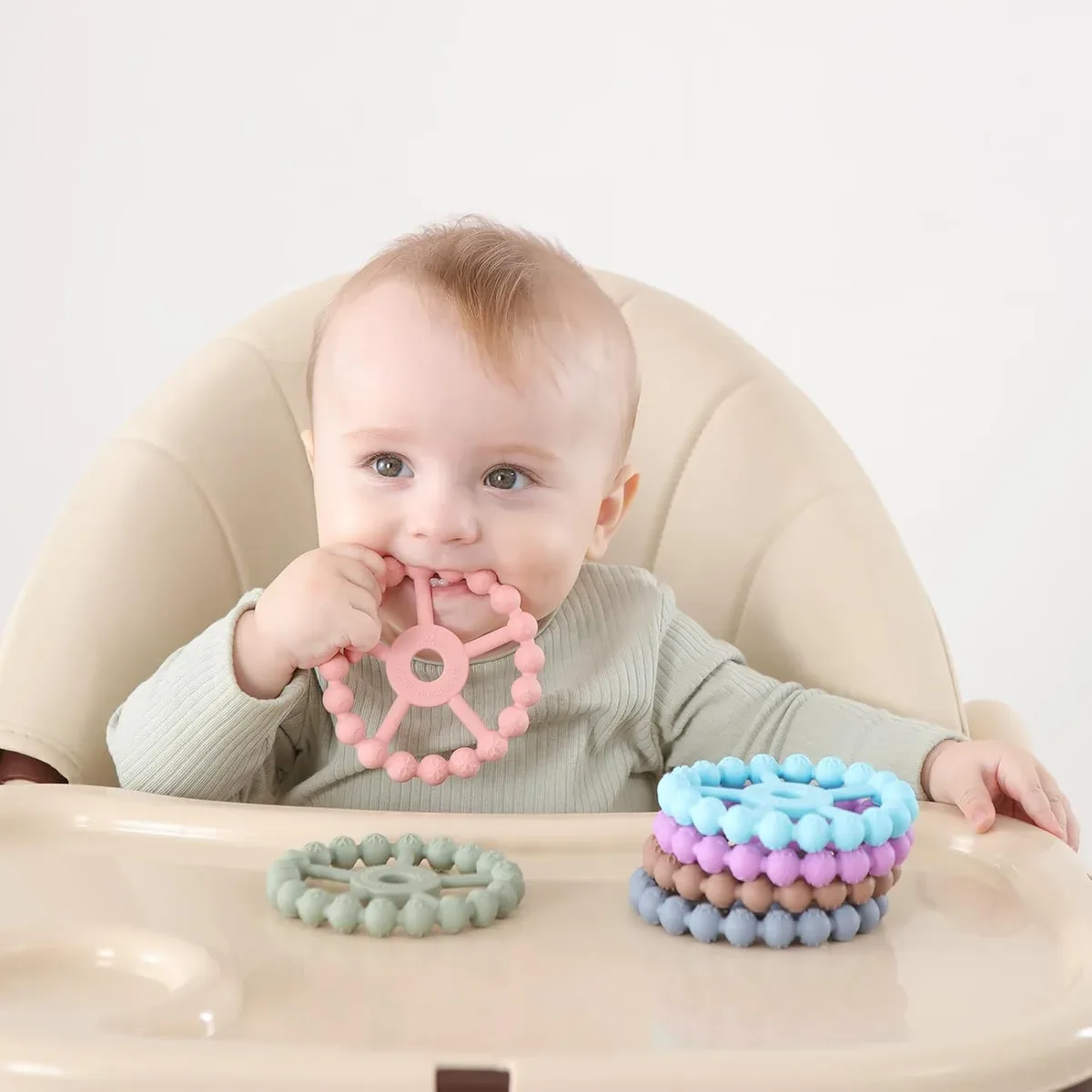 Baby soothing sore gums with a silicone ring teether