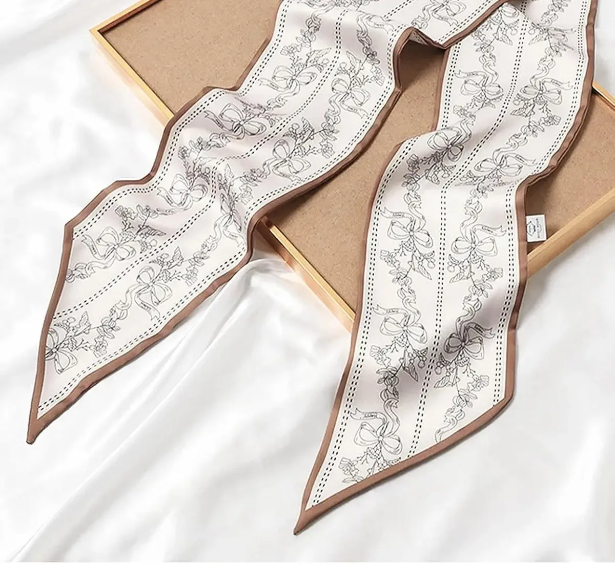Skinny satin scarf presented on a gift box