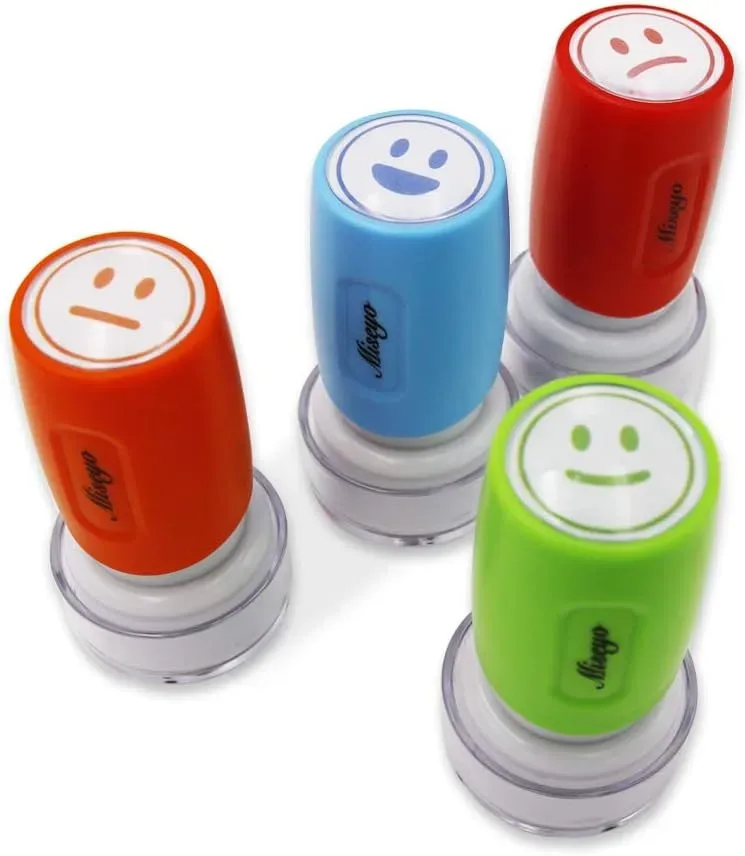 Four colors of the teacher smiley face stamp set