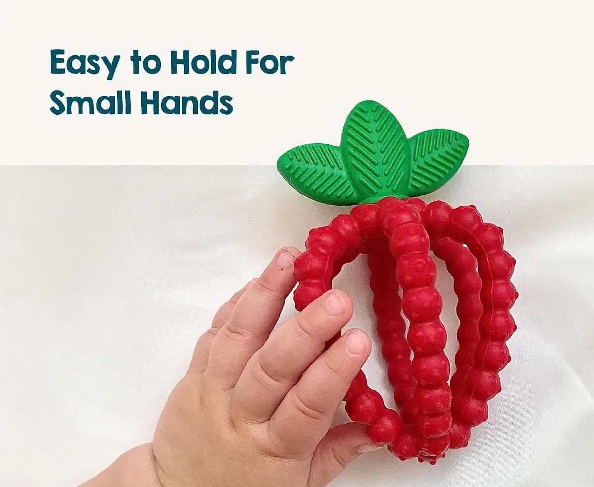 Small hand wrapped easily around the strawberry teether