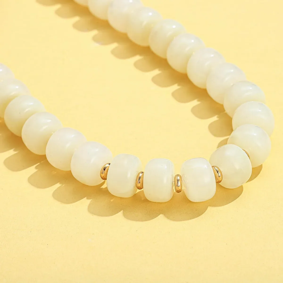 Detail of the glossy white beads on the chunky beaded necklace